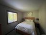 Bedroom featuring dark carpet