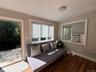Sitting room featuring wood finished floors and cooling unit