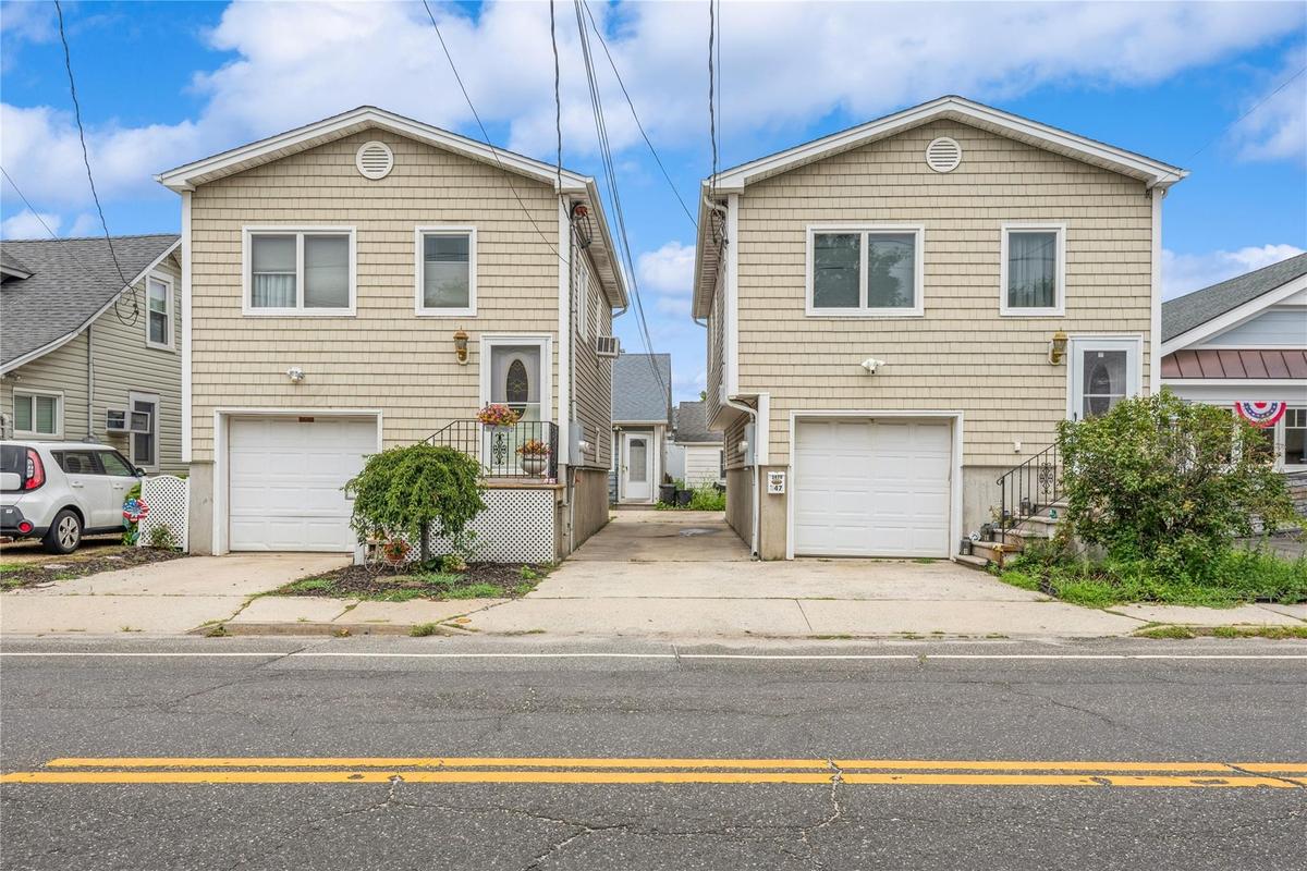Split level home with a garage and concrete driveway