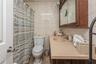 Full bathroom with vanity, tile walls, tasteful backsplash, tile patterned floors, and curtained shower
