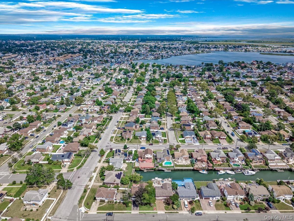 View of property location with a large body of water and nearby suburban area