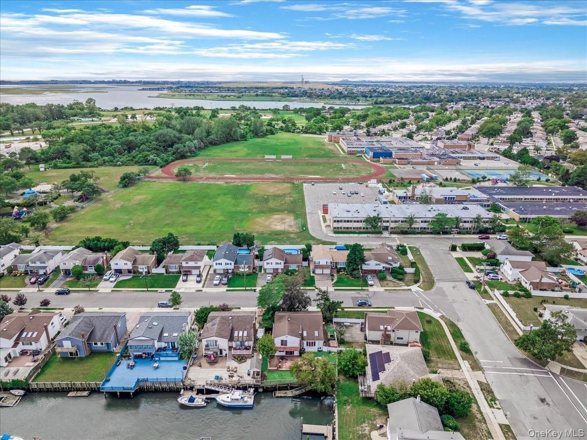 Aerial view of residential area featuring a large body of water