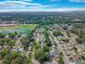 View of property location featuring nearby suburban area and a tree filled landscape