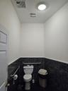 Bathroom with tile walls and wainscoting