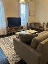 Living room with hardwood / wood-style floors and baseboards