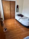 Bedroom featuring wood finished floors and a closet