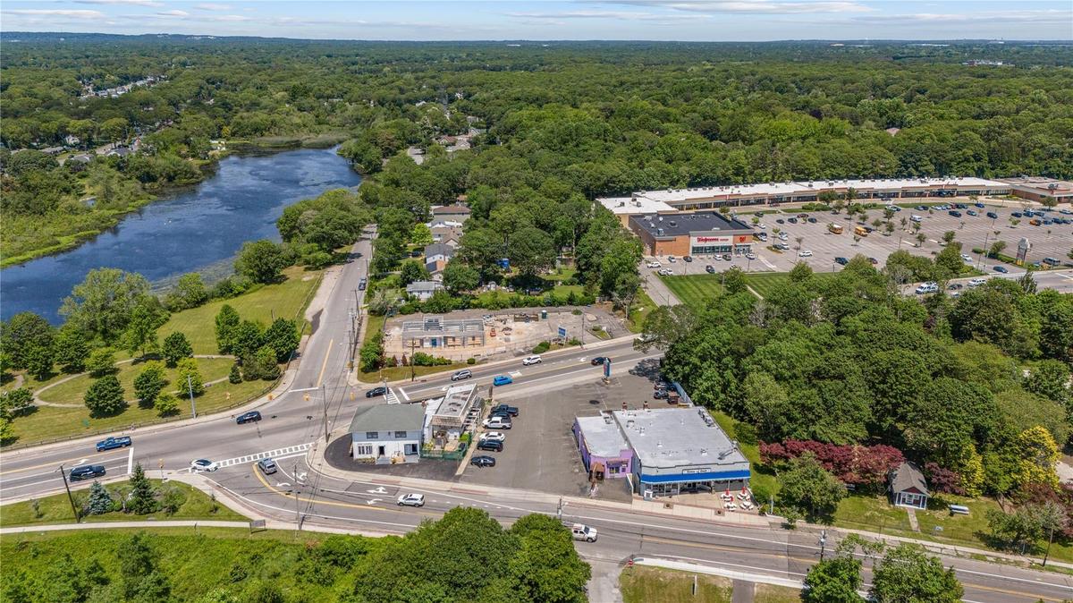 Bird's eye view of a heavily wooded area and a nearby body of water