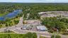 Bird's eye view of a heavily wooded area and a nearby body of water