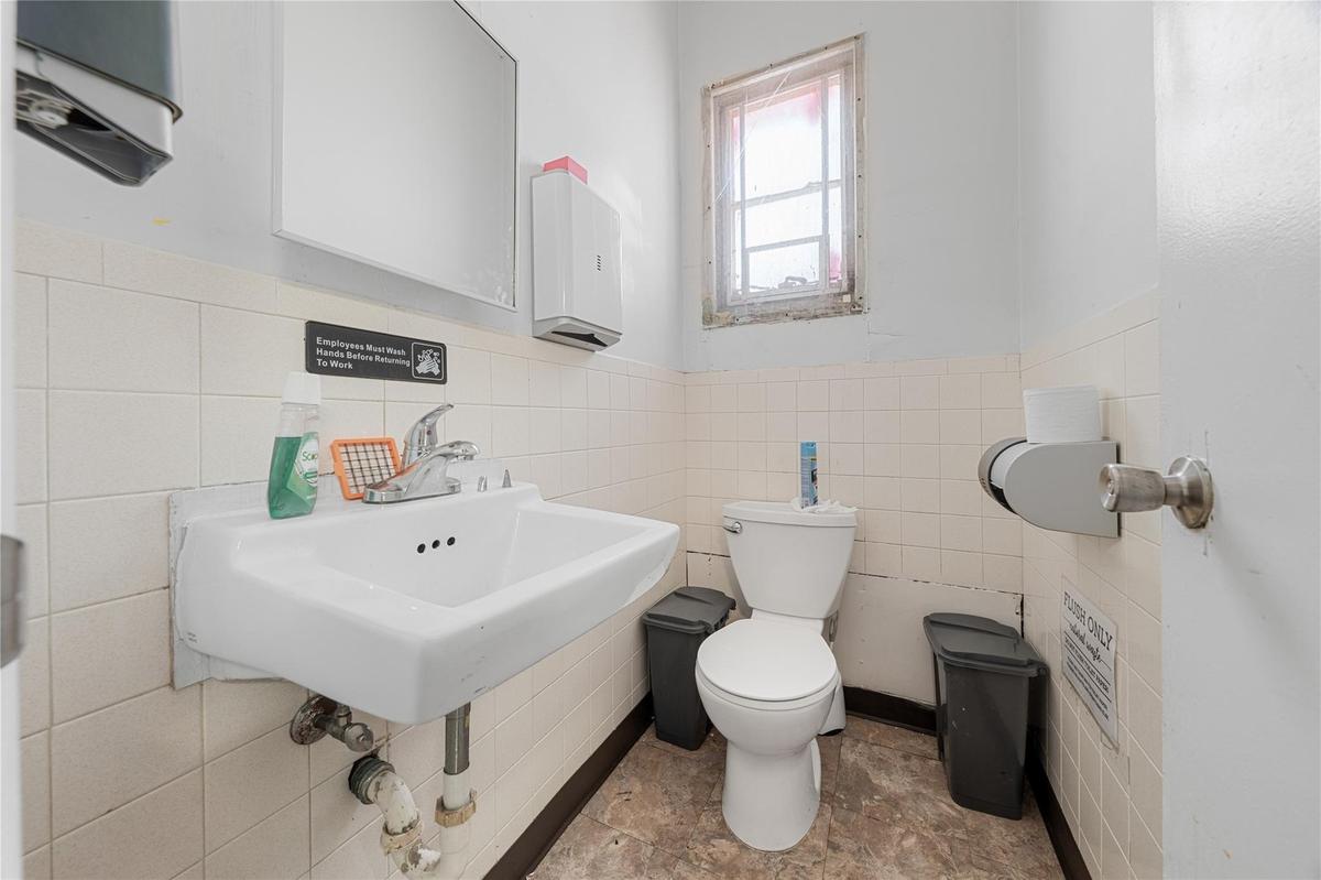 Bathroom featuring tile walls and a wainscoted wall