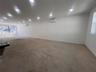 Spare room with an AC wall unit, concrete flooring, baseboards, and recessed lighting