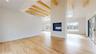 living room featuring beamed ceiling, light hardwood / wood-style floors