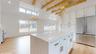 Kitchen with white cabinets, a center island, stainless steel appliances, and hanging light fixtures