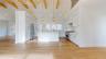 Kitchen with beam ceiling, white cabinetry, premium appliances, pendant lighting, and a kitchen island