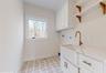 Laundry area with  hookup for washer/dryer, cabinets, and sink