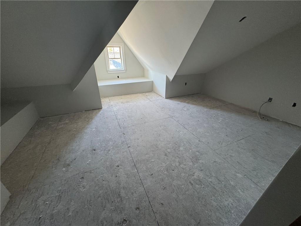 Additional living space featuring vaulted ceiling