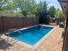 View of swimming pool featuring a patio and a fenced backyard