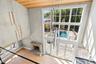 Doorway with plenty of natural light, wood finished floors, and wood ceiling