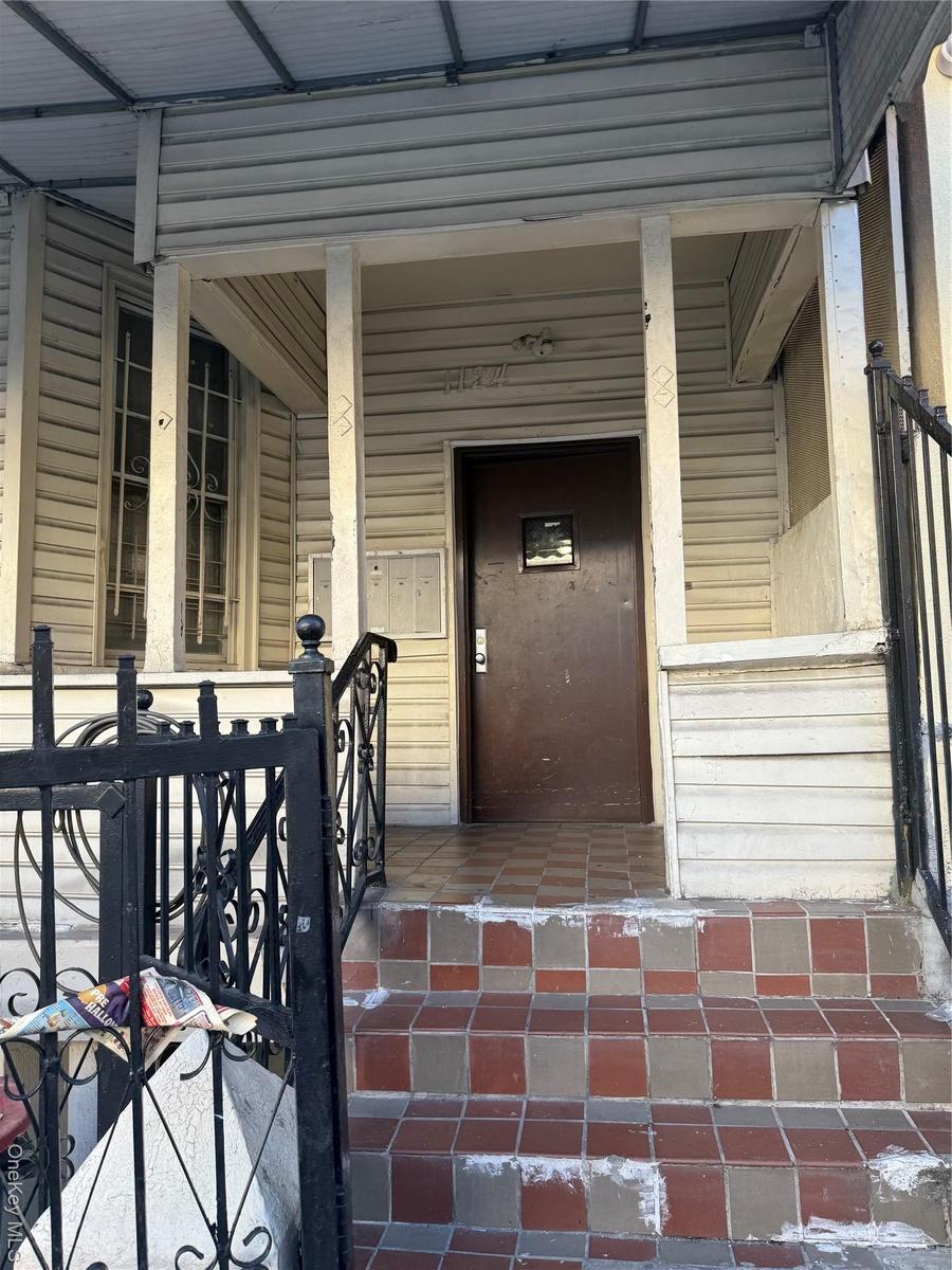 Property entrance with covered porch