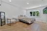 Bedroom with light wood finished floors and recessed lighting