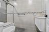 Bathroom featuring vanity, combined bath / shower with glass door, tile walls, and tile patterned flooring
