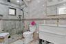 Full bathroom featuring vanity, tile walls, and a stall shower