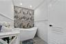 Full bathroom with a freestanding bath, tile walls, light marble finish flooring, a wainscoted wall, and recessed lighting