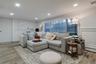 Living room with light wood-type flooring, recessed lighting, and a baseboard radiator