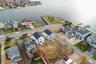 Aerial view of residential area featuring a nearby body of water