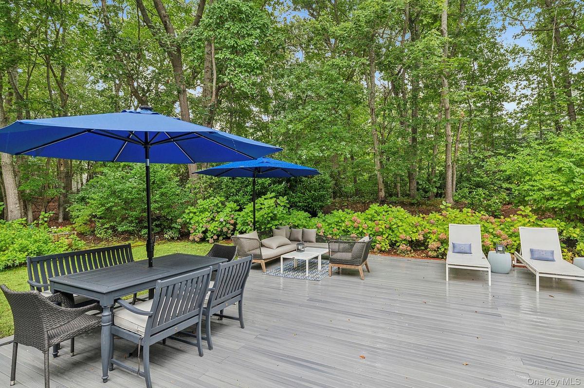 Wooden terrace featuring outdoor lounge area and outdoor dining space