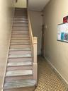 Staircase featuring concrete block wall