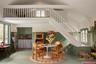 Dining space with stairway and a high ceiling