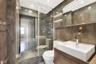 Full bathroom with vanity, a shower stall, tile walls, and recessed lighting