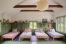 Bedroom featuring beamed ceiling and high vaulted ceiling