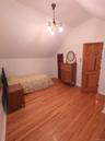 Bedroom with lofted ceiling and light wood-style flooring