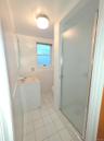 Bathroom with vanity, light tile patterned floors, a shower stall, and tile walls