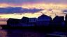 Back of house at dusk with a deck