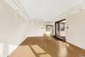 Empty room with light wood-style floors and recessed lighting