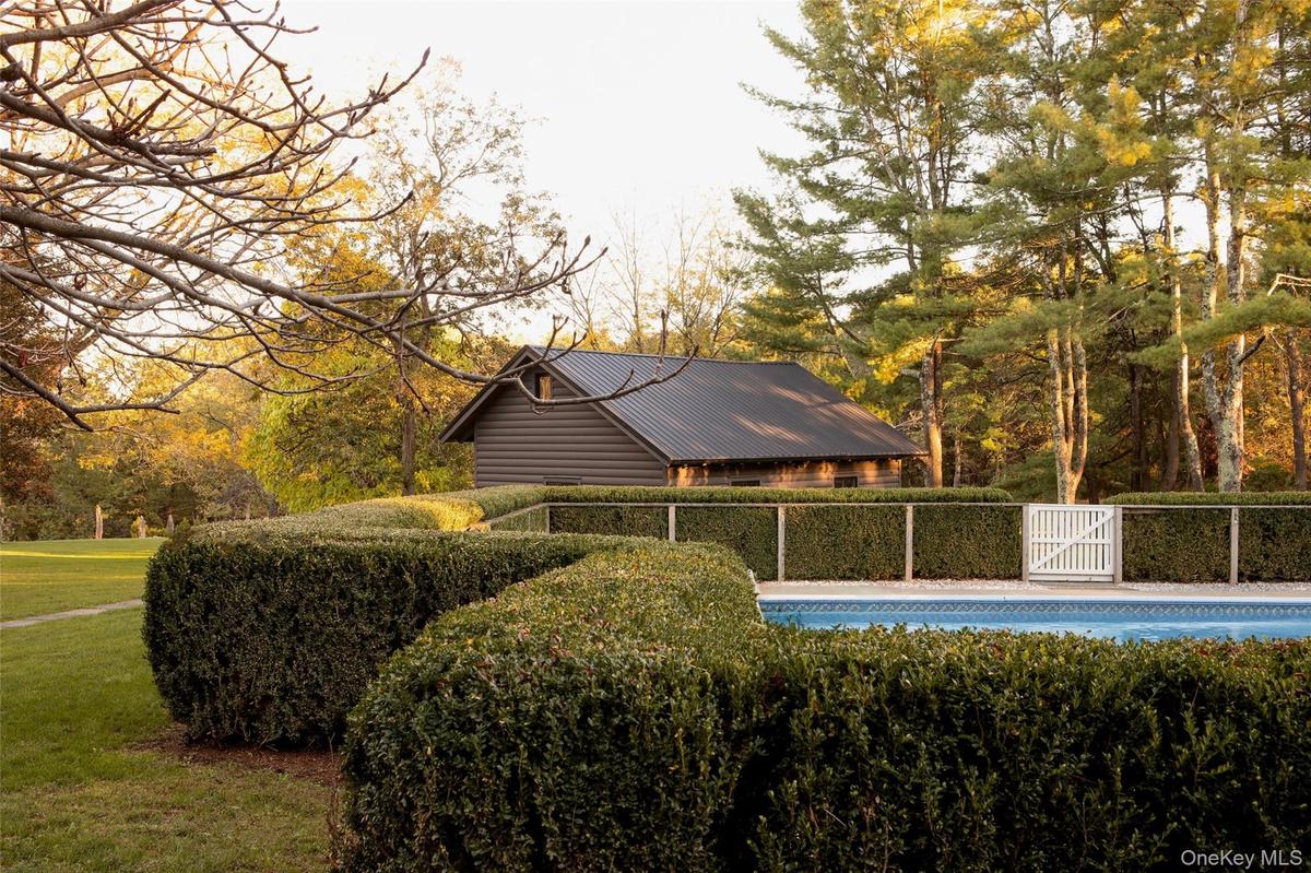 View of swimming pool with view of wooded area