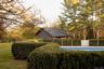 View of swimming pool with view of wooded area