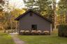 View of side of property with log veneer siding and a lawn