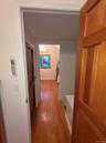 Hallway with light wood finished floors and baseboards