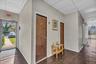 Hallway featuring dark wood-style floors and a drop ceiling