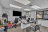Office space featuring light wood-style flooring and a paneled ceiling