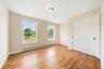 Unfurnished bedroom with light wood-type flooring, a closet, and a baseboard heating unit