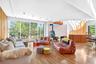 Living room with sliding doors to deck and wood stove.