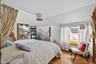 Bedroom with lofted ceiling and wood finished floors
