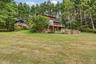 View of grassy yard featuring a wooden deck