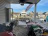 Deck featuring a residential view, an outdoor hangout area, and ceiling fan