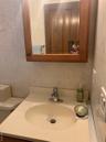 Bathroom featuring vanity and tile walls