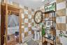Ensuite bathroom featuring tile walls and a baseboard radiator